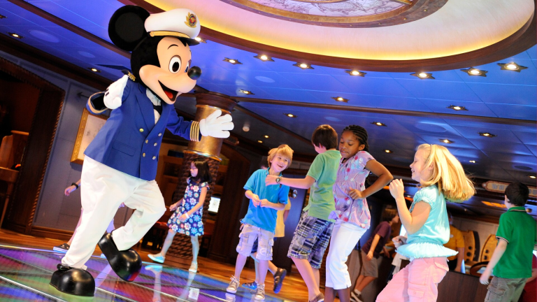 Dressed as a skipper, Mickey Mouse dances with kids on an illuminated dance floor_oceaneer Lab