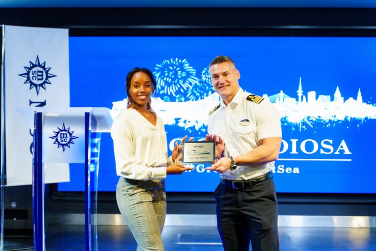 Captain Danilo Cha of MSC Grandiosa exchanges plaques with Autria Bethel, Operations Coordinator, Nassau Cruise Port.