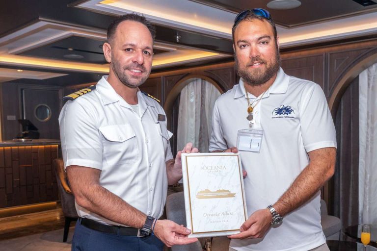 Oceania Allura s Captain Pavle Silic exchanges plaques with Tucker Maura, Operations Coordinator, Nassau Cruise Port.